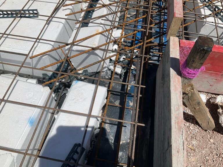 Building inspector checking formwork and steel reinforcement installation during pre pour inspection in Sydney home.