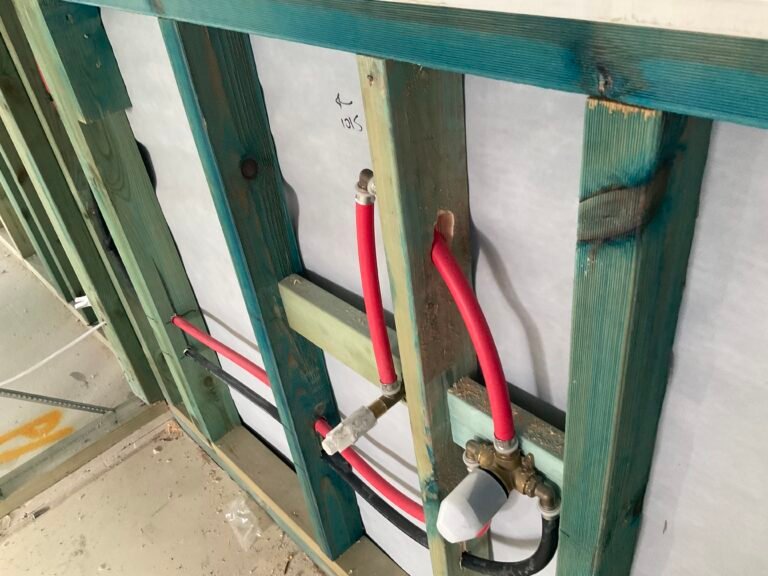 Inspecting plumbing rough in during lock-up stage inspection.